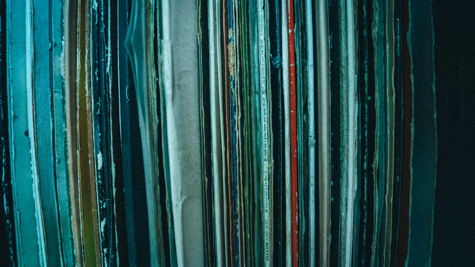 Bound ledgers stacked on a shelf in an accounts room