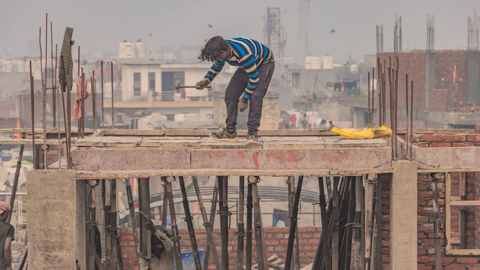 Bamboo scaffolding lashed into a structure that carries real load