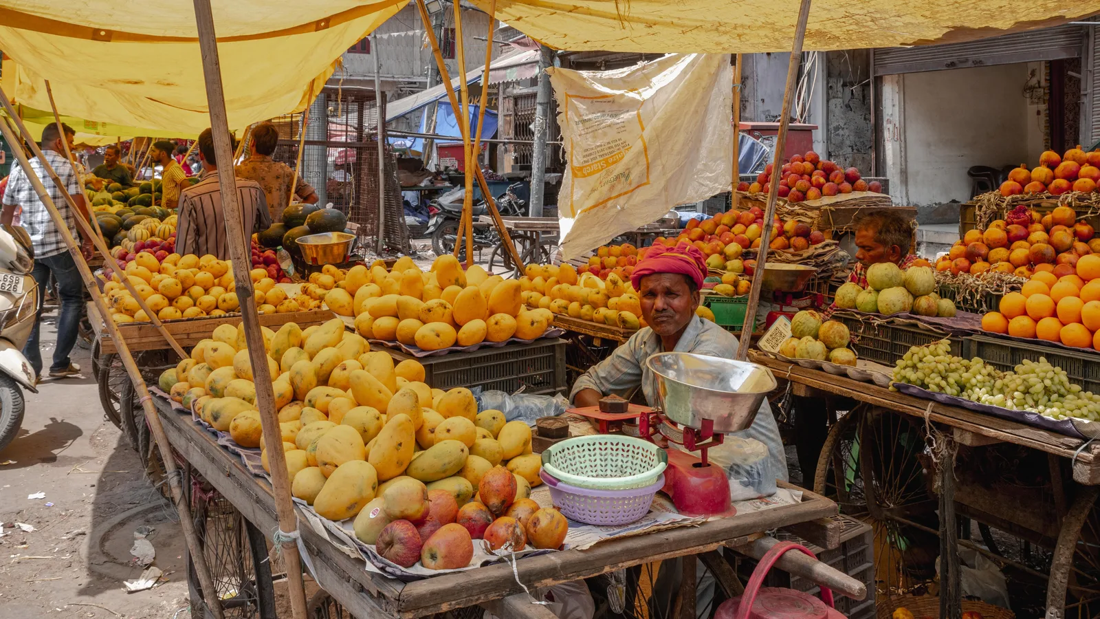 A handwritten price board at an Indian market stall, visible to every customer