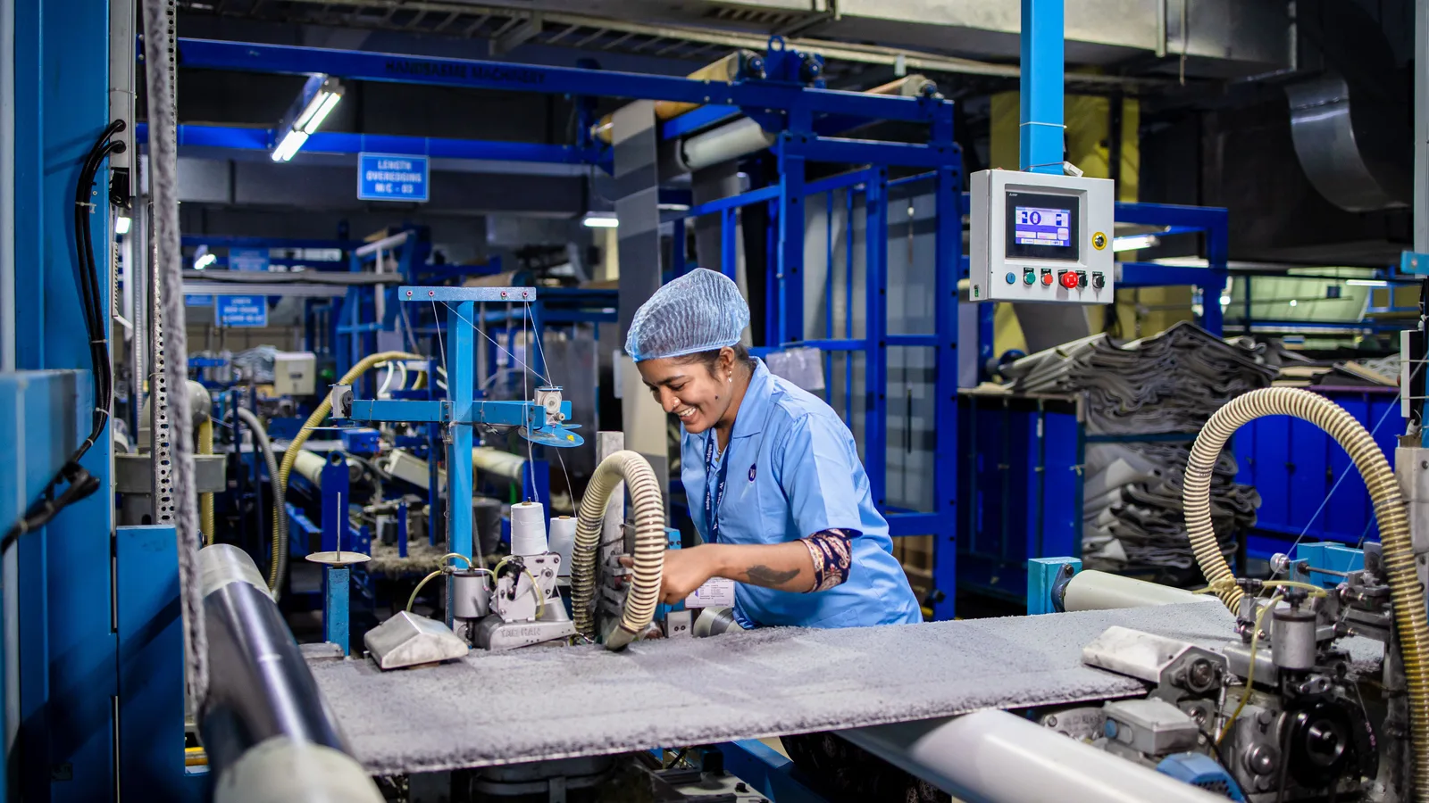 An inspector checking machinery on a factory floor rather than its paperwork